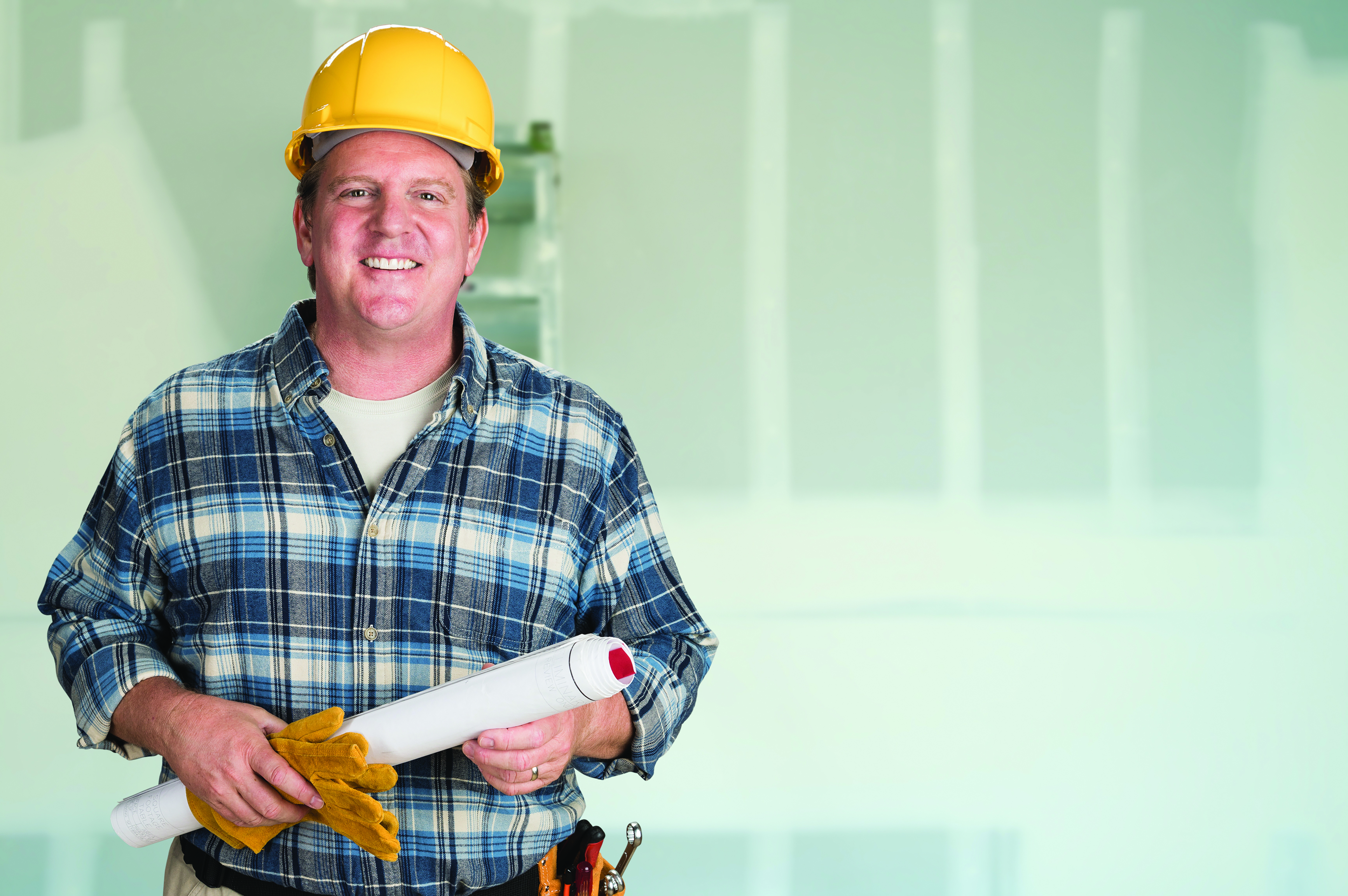 Bigstock flooring contractor holding plans, wearing a hard hat. 